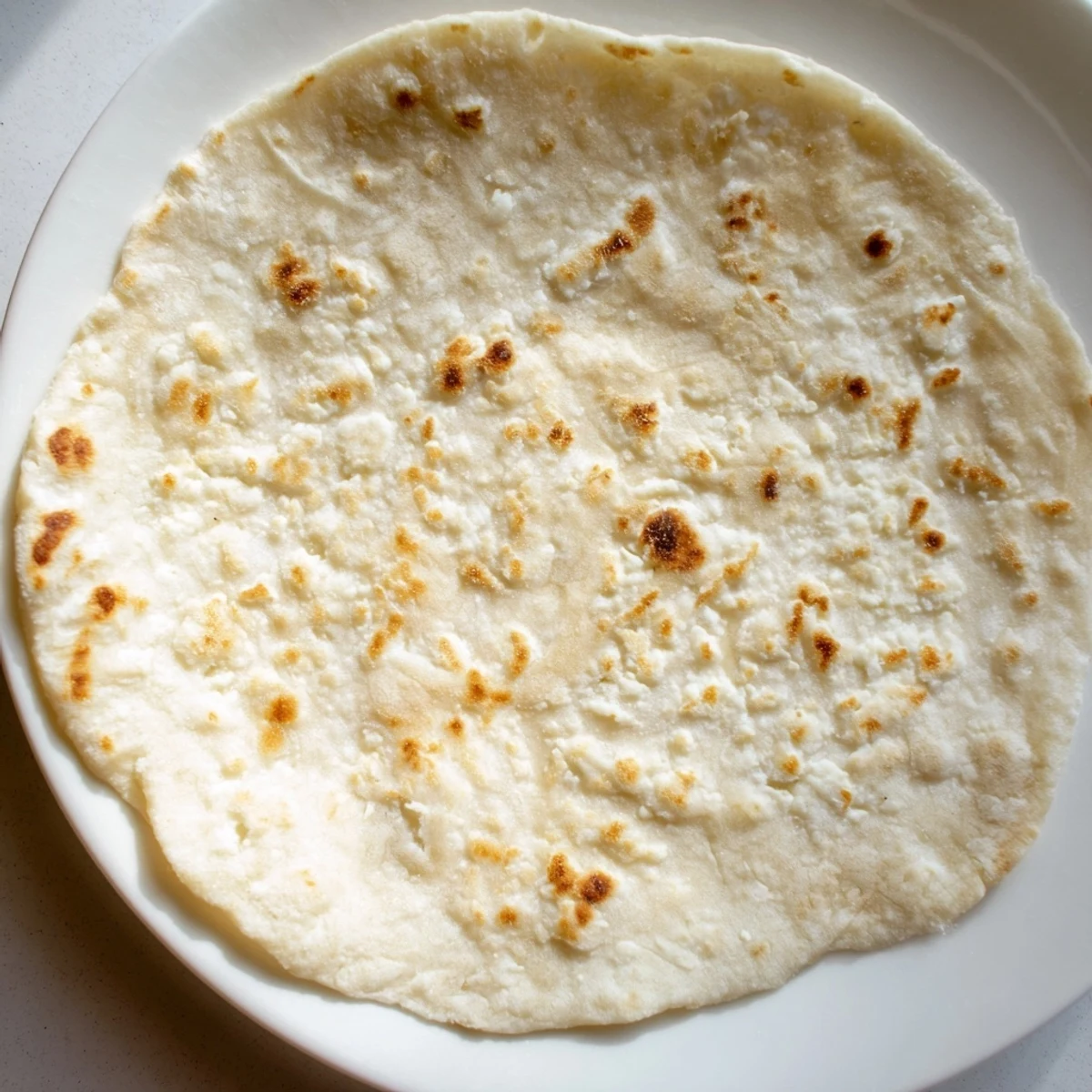 Warm, golden-brown cottage cheese flatbread, pan-fried to perfection, ready to be enjoyed with a dip.