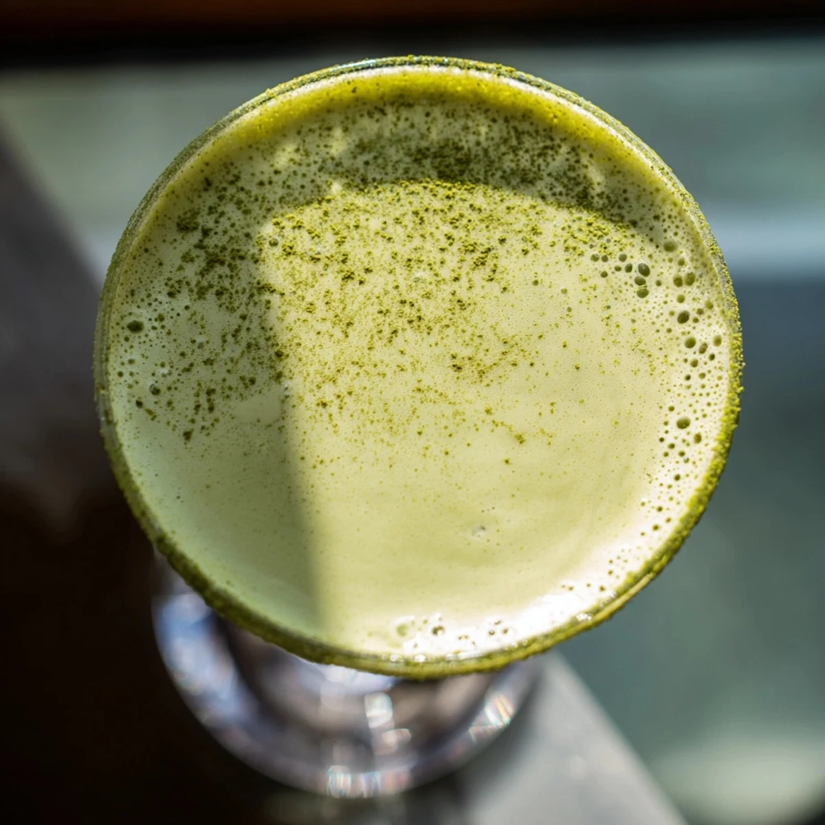 Smooth Matcha Martini Cocktail with creamy layers and a subtle matcha swirl, set against a minimalist kitchen backdrop.