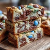 Chewy Cadbury Egg Cookie Bars with colorful pastel M&Ms, perfect for Easter dessert tables.  