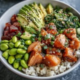Delicious poke bowl featuring marinated salmon, crunchy vegetables, and fluffy rice.