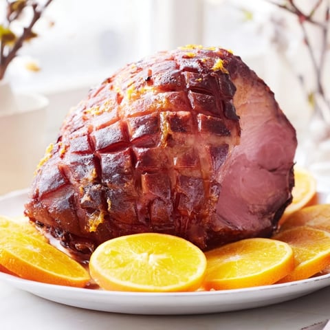 Golden, glistening photo of Slow-Cooked Honey Glazed Ham ready to serve at a holiday feast.