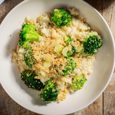 A close-up of a steaming bowl of Cheesy Broccoli and Rice All-in-One Bake, with melted cheese.