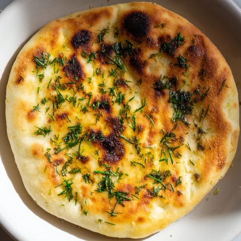 Chewy Quick Homemade Flatbread with visible rosemary, perfect for dipping or enjoying as a snack.