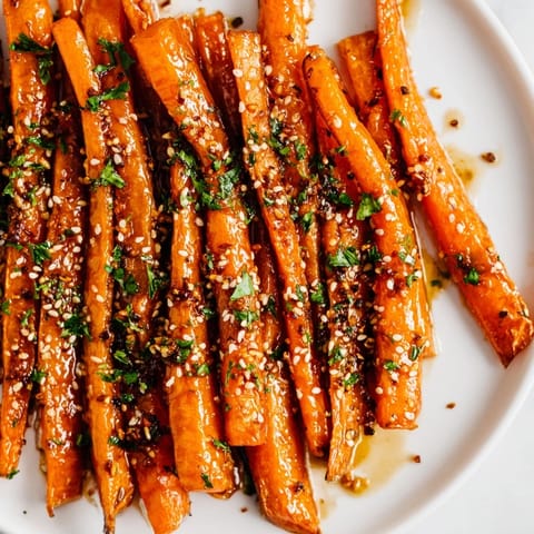Close-up of glazed Maple Mustard Roasted Carrots, showcasing their tender texture and sweetness.
