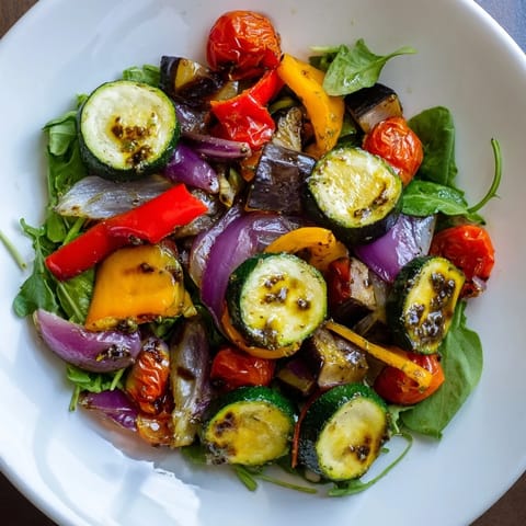 A colorful serving of Mediterranean Roasted Vegetable Salad, bursting with fresh, roasted flavors.
