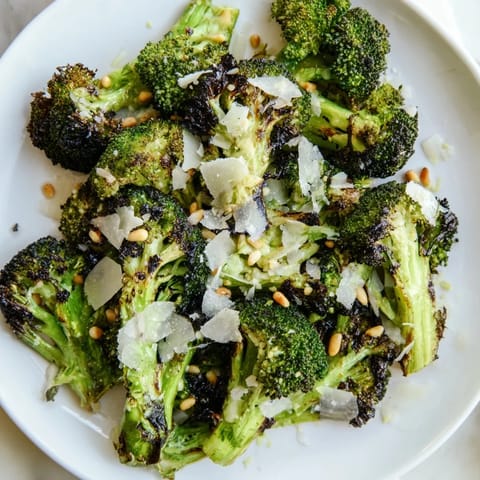 Smoky charred broccoli salad, visually appealing with roasted edges and fresh garnish, perfect for any meal.
