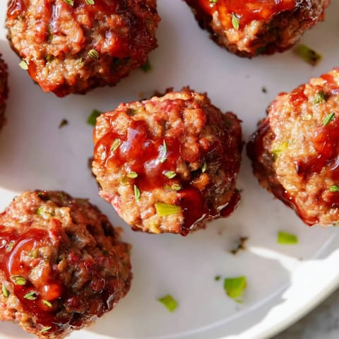 Warm, savory mini meatloaf bites, baked to perfection, smell absolutely delicious with a sweet topping.