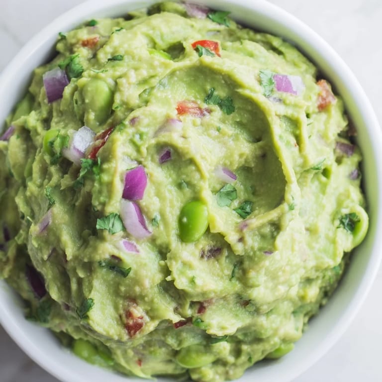 Enjoy the bright flavors of this vegan Edamame Guacamole, ready to serve as a delicious snack.