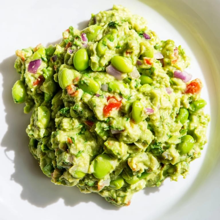 Close-up of freshly made Edamame Guacamole, perfect for scooping with crisp tortilla chips.