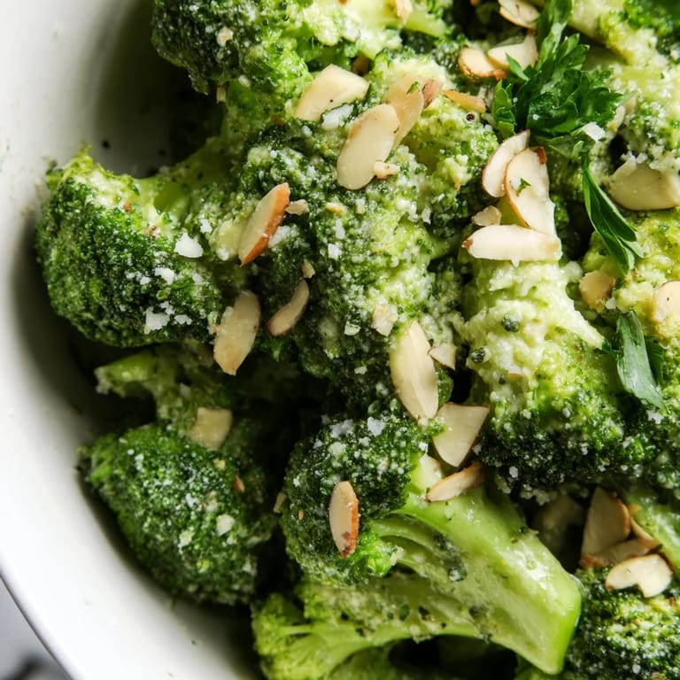 Blanched broccoli salad tossed with red onion and toasted almonds in a savory garlic Parmesan dressing.
