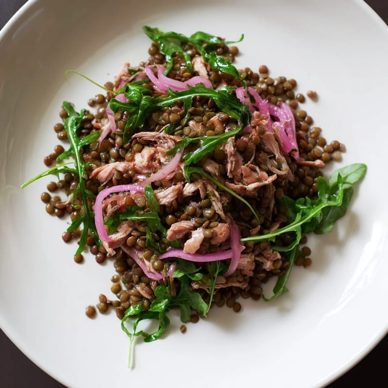 Overhead view of Lentil & Chicken Spring Salad, a protein-packed bowl of lentils, roasted chicken, and arugula, perfect for a light lunch.