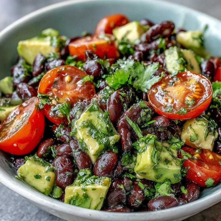 Freshly prepared Black Bean and Veggie Bowl featuring corn, tomatoes, and cilantro, tossed in a zesty lime vinaigrette.