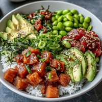 Vibrant salmon poke bowl with creamy avocado, edamame, and fresh veggies.